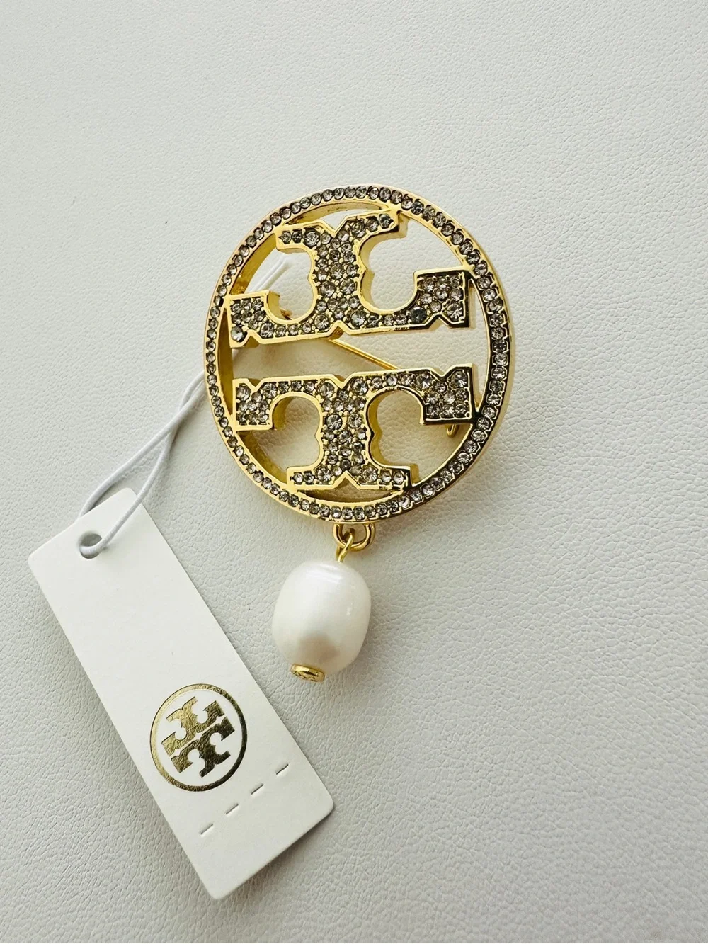 Tory Burch Gold-Tone Crystal Logo Brooch with White Pearl Drop